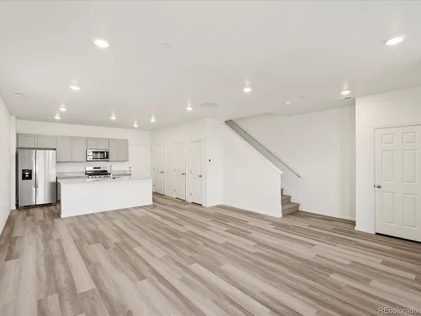 a view of kitchen with microwave and cabinets