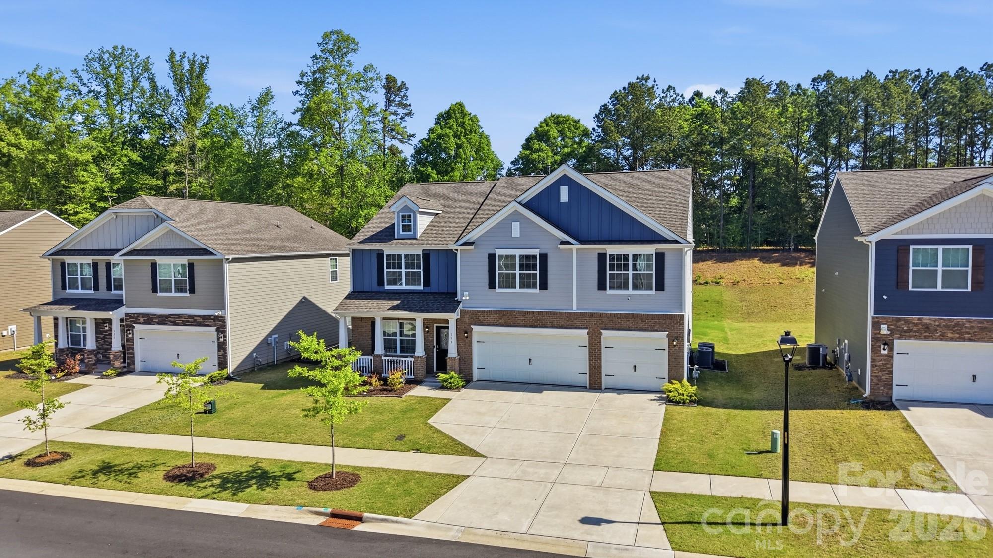 116 Timbergreen Court Troutman, NC 28166 - Photo 38 of 43 a front view of a house with a garden and trees