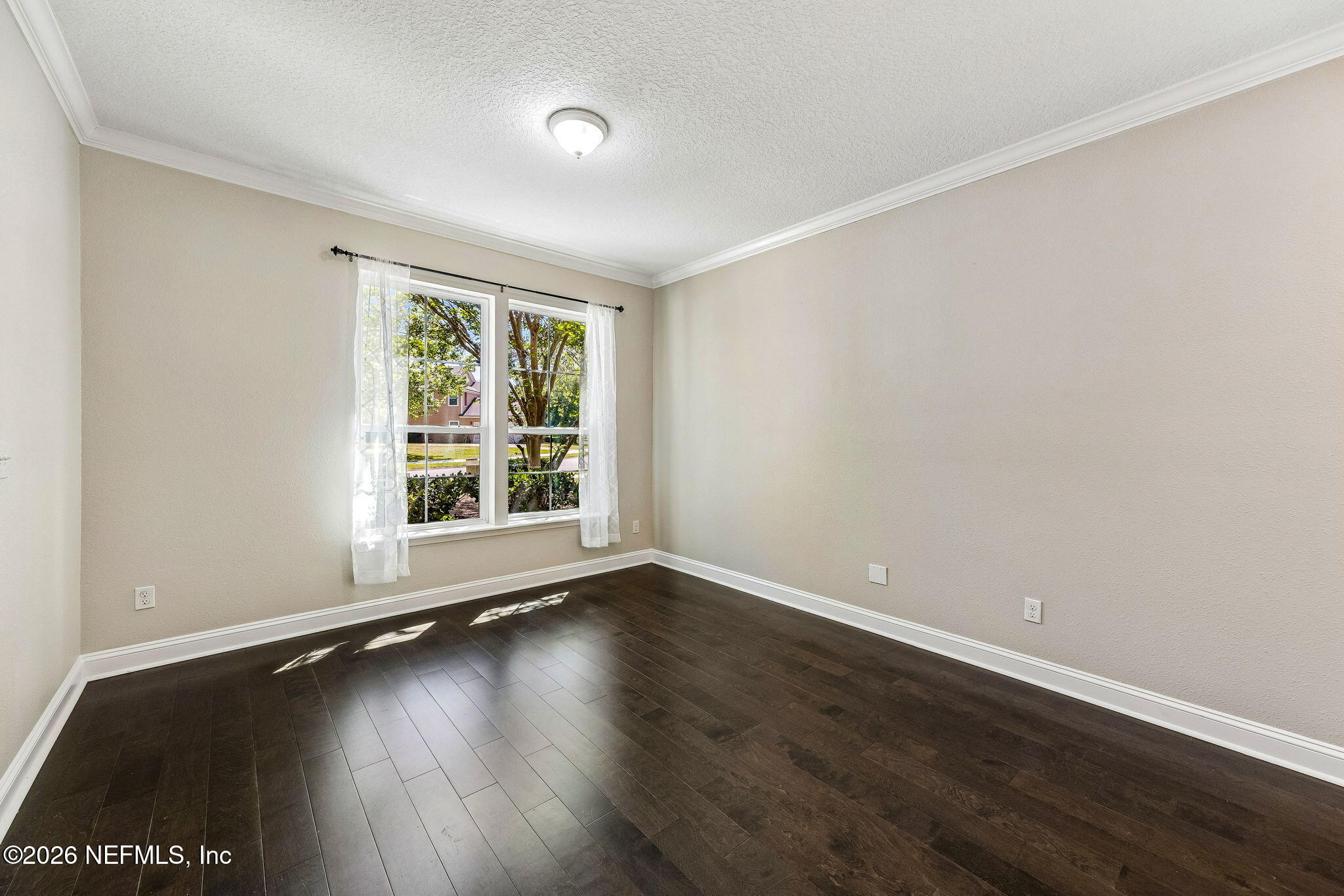 12198 Ridge Crossing Way Jacksonville, FL 32226 - Photo 9 of 67 a view of an empty room with wooden floor and a window