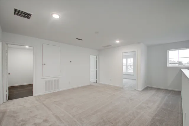 an empty room with windows and closet