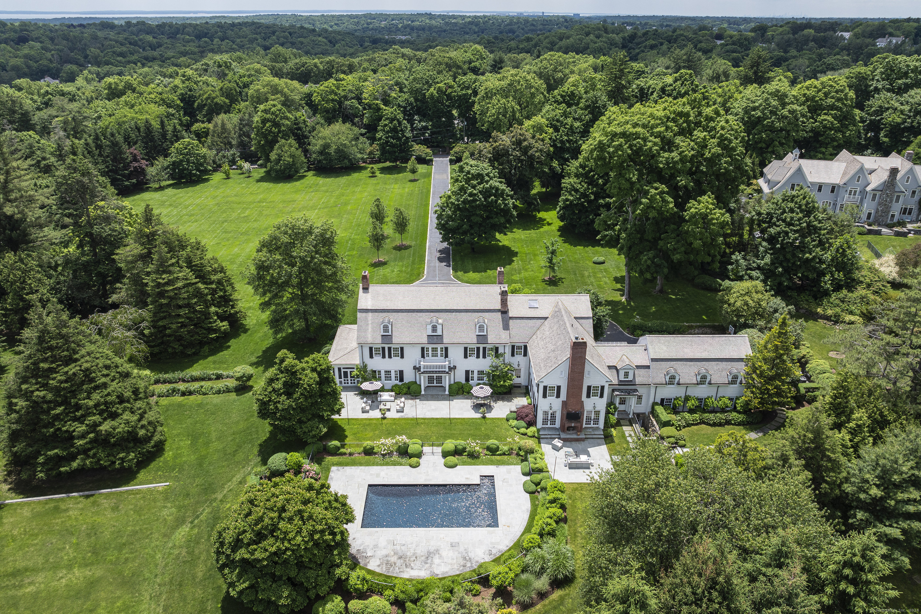 an aerial view of a house with yard outdoor seating and lake view