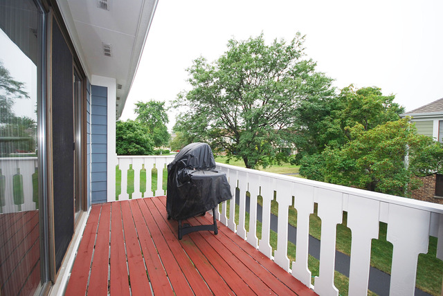 550 Greystone Lane, Unit A2 Wheeling, IL 60090 - Photo 17 of 23 a view of balcony with wooden floor and fence