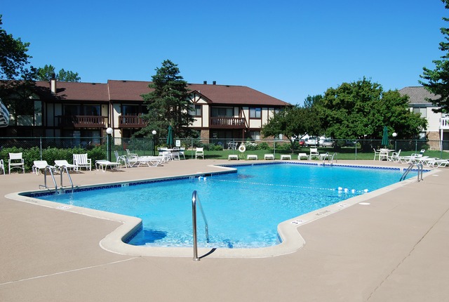 550 Greystone Lane, Unit A2 Wheeling, IL 60090 - Photo 20 of 23 a view of swimming pool with outdoor seating and a garden