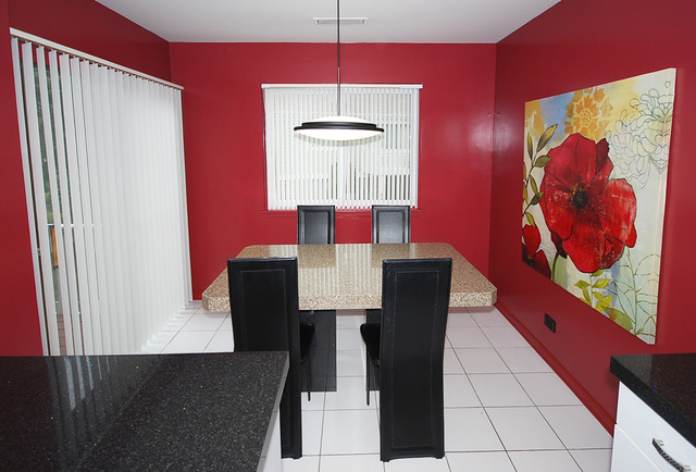 550 Greystone Lane, Unit A2 Wheeling, IL 60090 - Photo 8 of 23 a dining room with furniture and wooden floor