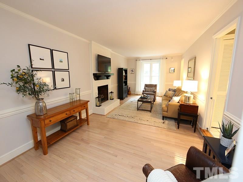 8320 Wheatstone Lane Raleigh, NC 27613 - Photo 2 of 23 Bright oversized Living Room with hardwood floors and masonry fireplace.