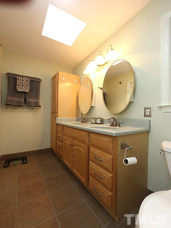 8320 Wheatstone Lane Raleigh, NC 27613 - Photo 14 of 23 Remodeled with tile shower, 2 sinks and plenty of cabinet space.