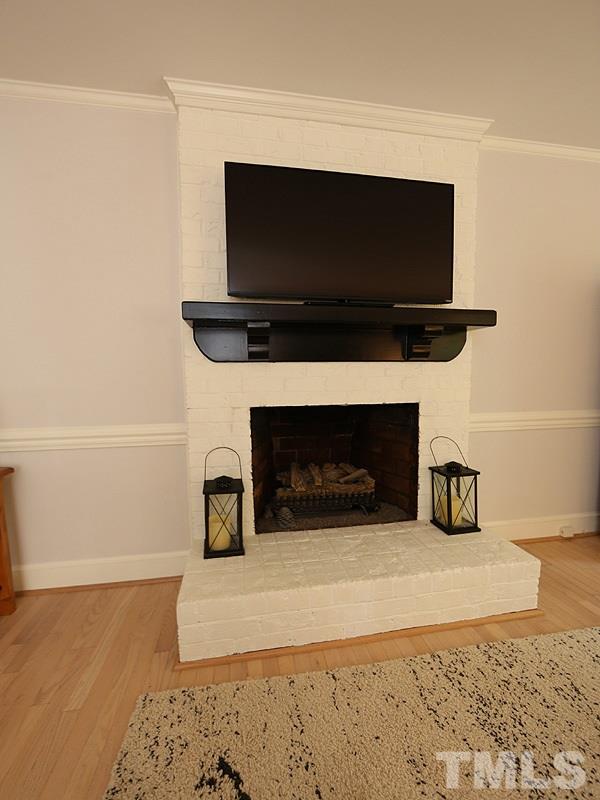 8320 Wheatstone Lane Raleigh, NC 27613 - Photo 4 of 23 Masonry fireplace with gas logs.