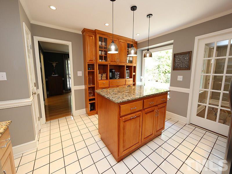 8320 Wheatstone Lane Raleigh, NC 27613 - Photo 8 of 23 Island with pull out trash bins plus wall of addition cabinets.