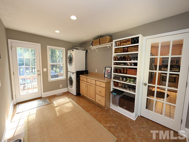 8320 Wheatstone Lane Raleigh, NC 27613 - Photo 10 of 23 Extra large mudroom measures 9.5'x14.5' and includes laundry area, cabinets, shelves and folding table plus plenty of space for a dog crate, stroller, etc.