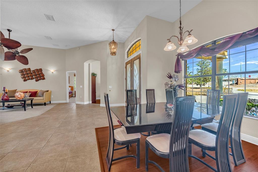 13101 Shadow Run Boulevard Riverview, FL 33569 - Photo 13 of 86 a view of a dining room with furniture a chandelier and large windows