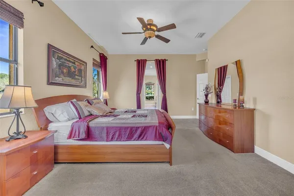 a large kitchen with kitchen island granite countertop a large counter top stainless steel appliances a sink cabinets and living room view