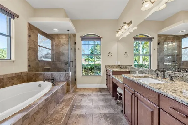 a living room with furniture a flat screen tv and a chandelier