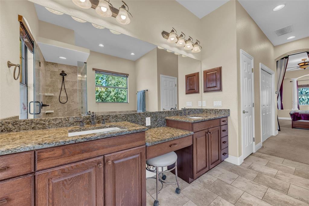 13101 Shadow Run Boulevard Riverview, FL 33569 - Photo 28 of 86 a bathroom with a granite countertop double vanity sink a mirror and a