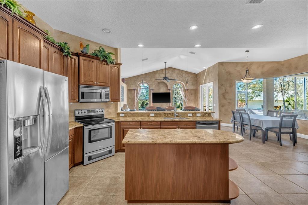13101 Shadow Run Boulevard Riverview, FL 33569 - Photo 34 of 86 a kitchen with kitchen island granite countertop a stove and a sink
