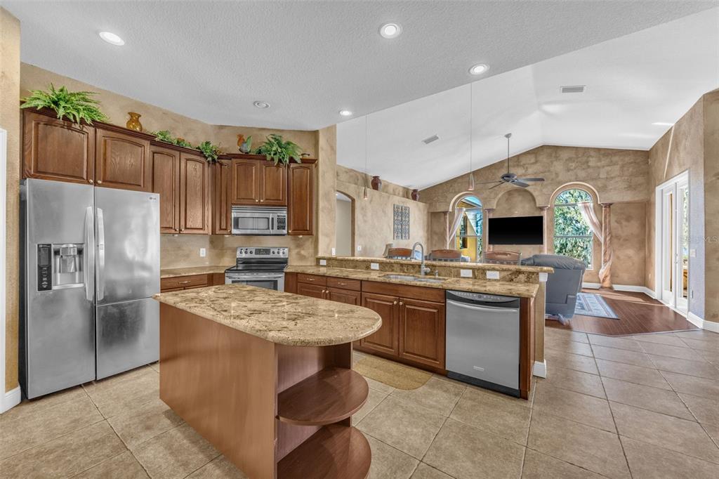 13101 Shadow Run Boulevard Riverview, FL 33569 - Photo 37 of 86 a kitchen with stainless steel appliances granite countertop a sink stove and refrigerator