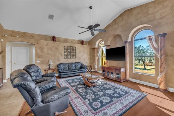 a living room with furniture a table and a chandelier