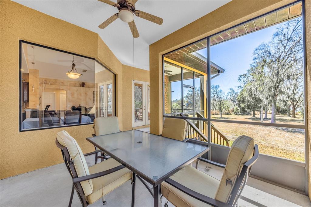 13101 Shadow Run Boulevard Riverview, FL 33569 - Photo 44 of 86 a view of a dining room with furniture and a floor to ceiling window