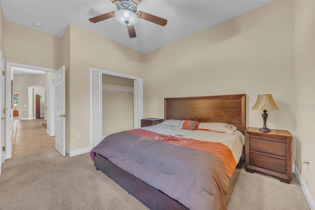 13101 Shadow Run Boulevard Riverview, FL 33569 - Photo 46 of 86 a bedroom with a bed and a chandelier