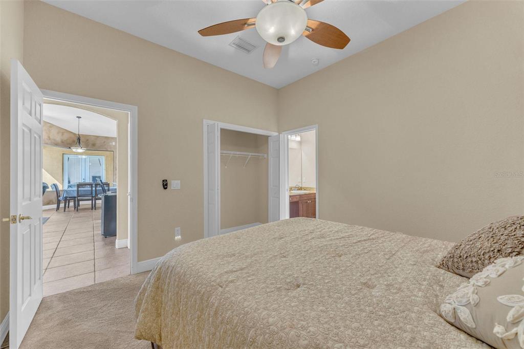 13101 Shadow Run Boulevard Riverview, FL 33569 - Photo 54 of 86 a bedroom with a bed and a chandelier