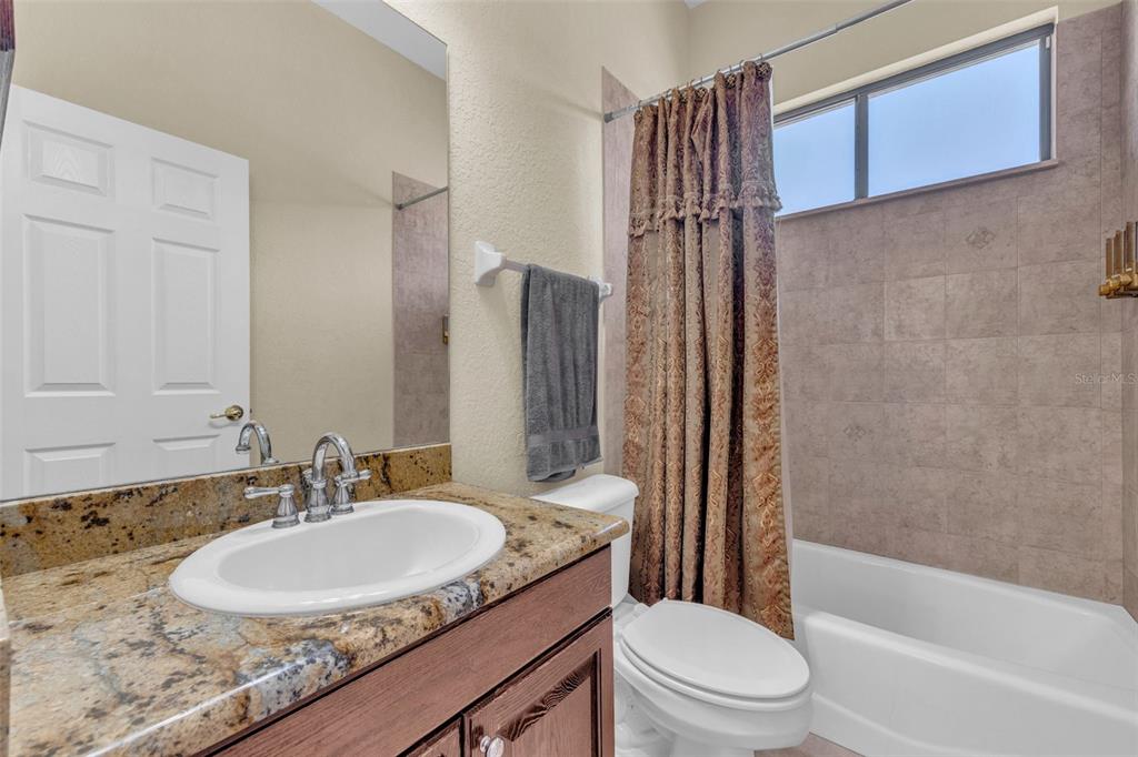 13101 Shadow Run Boulevard Riverview, FL 33569 - Photo 57 of 86 a bathroom with a granite countertop sink toilet and shower