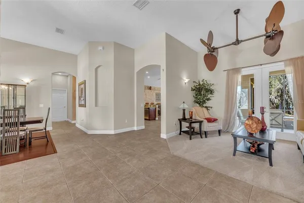a living room with furniture and a potted plant