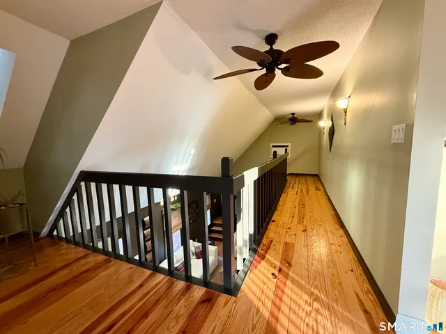 a view of entryway and hall with wooden floor