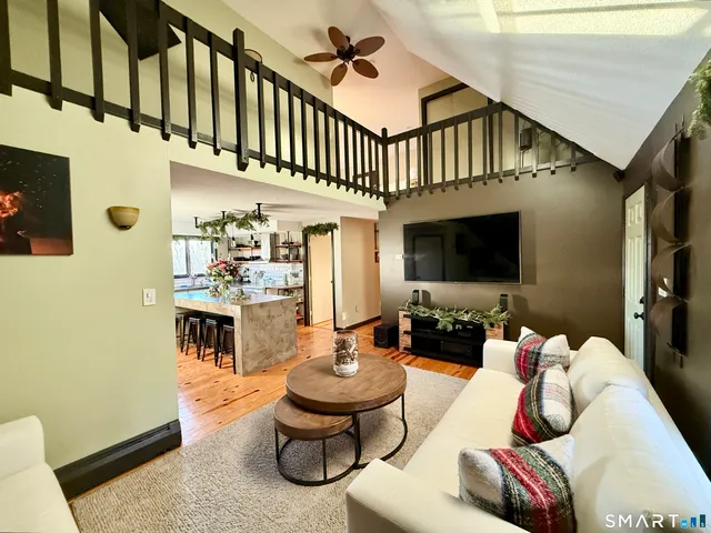 a living room with furniture fireplace and flat screen tv