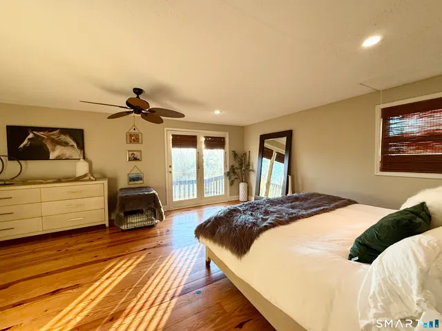 a bedroom with a bed and a view of kitchen