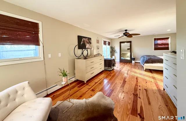 a bedroom with a bed and wooden floor