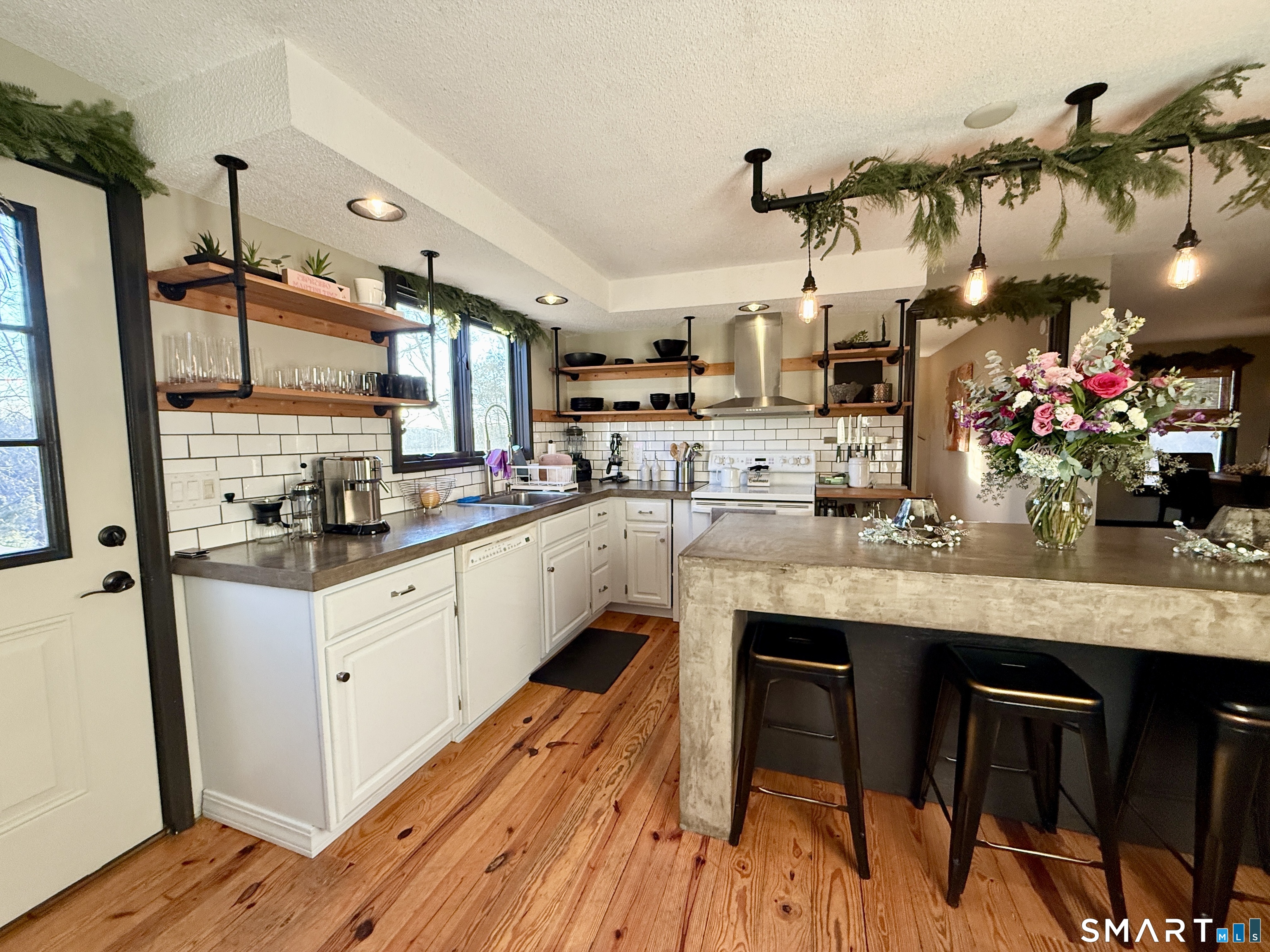 105 Riverside Drive Meriden, CT 06451 - Photo 23 of 27 a kitchen with granite countertop white cabinets and chairs