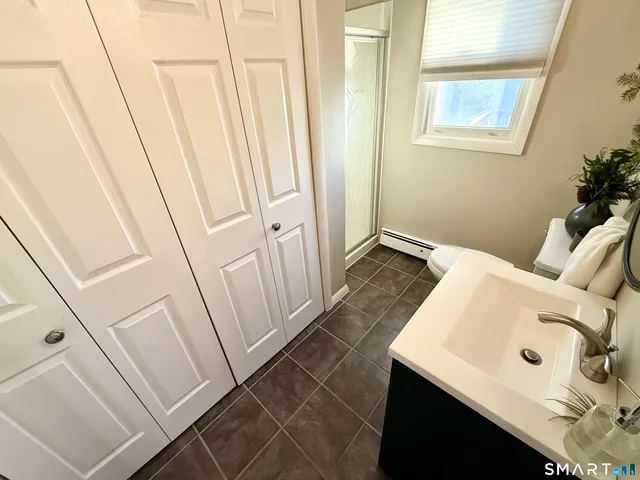 a bathroom with a sink and a window