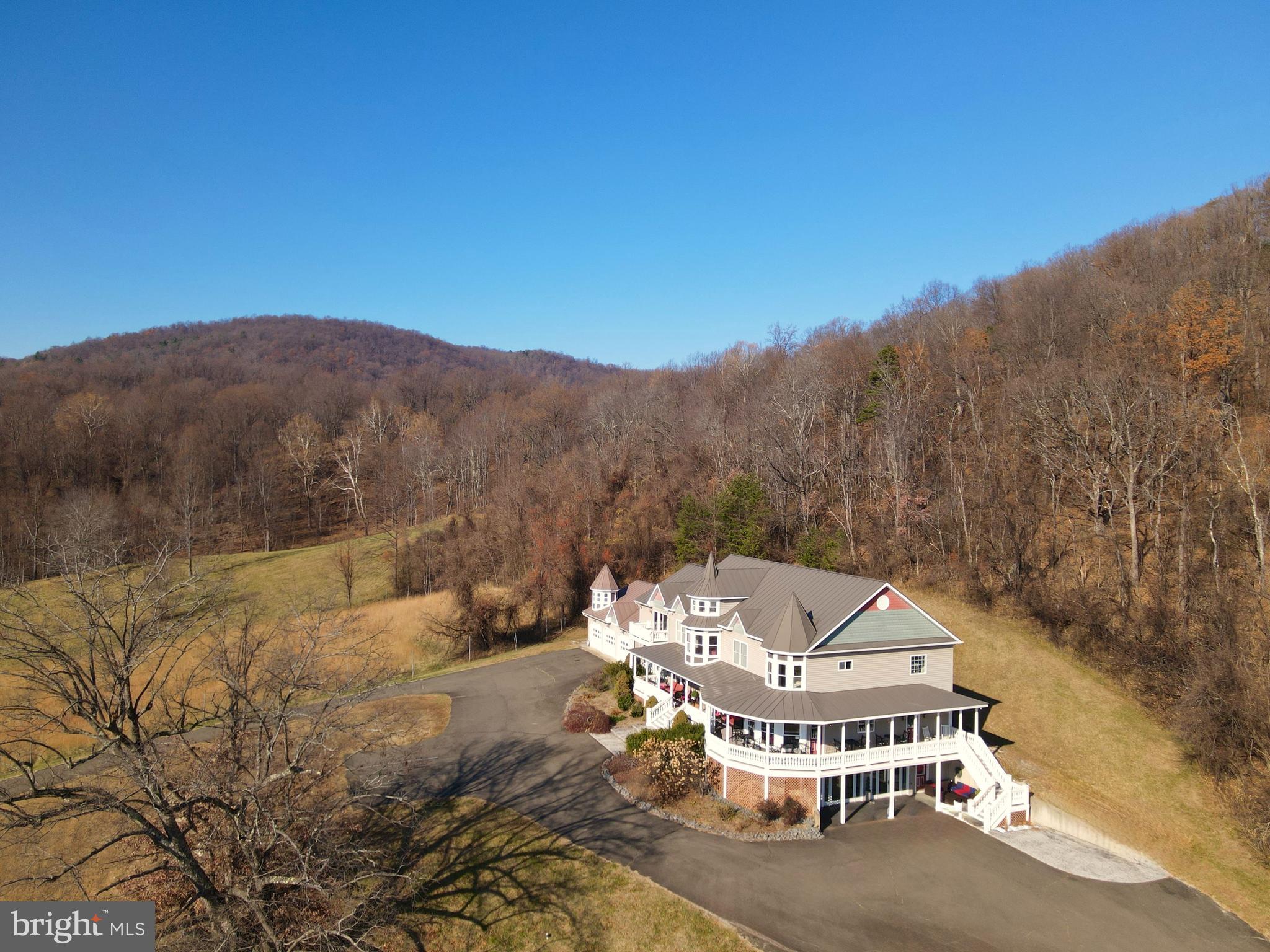 a view of a white house with a mountain yard and mountain view