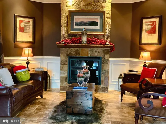 a living room with a bed furniture and a flat screen tv