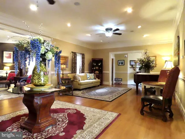 a living room with fireplace furniture and a potted plant