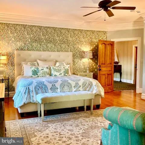 a view of a patio with dining table and chairs with wooden floor