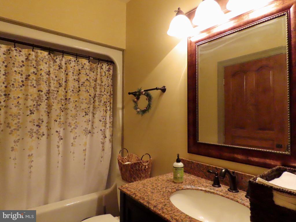 65 Clark Lane Washington, VA 22747 - Photo 47 of 62 a bathroom with a granite countertop sink and a mirror