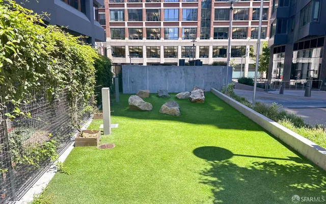 a view of an apartment with a backyard