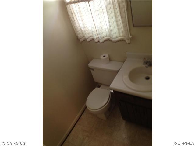 406 Rustic Drive Carson, VA 23830 - Photo 8 of 8 a bathroom with a toilet and a sink