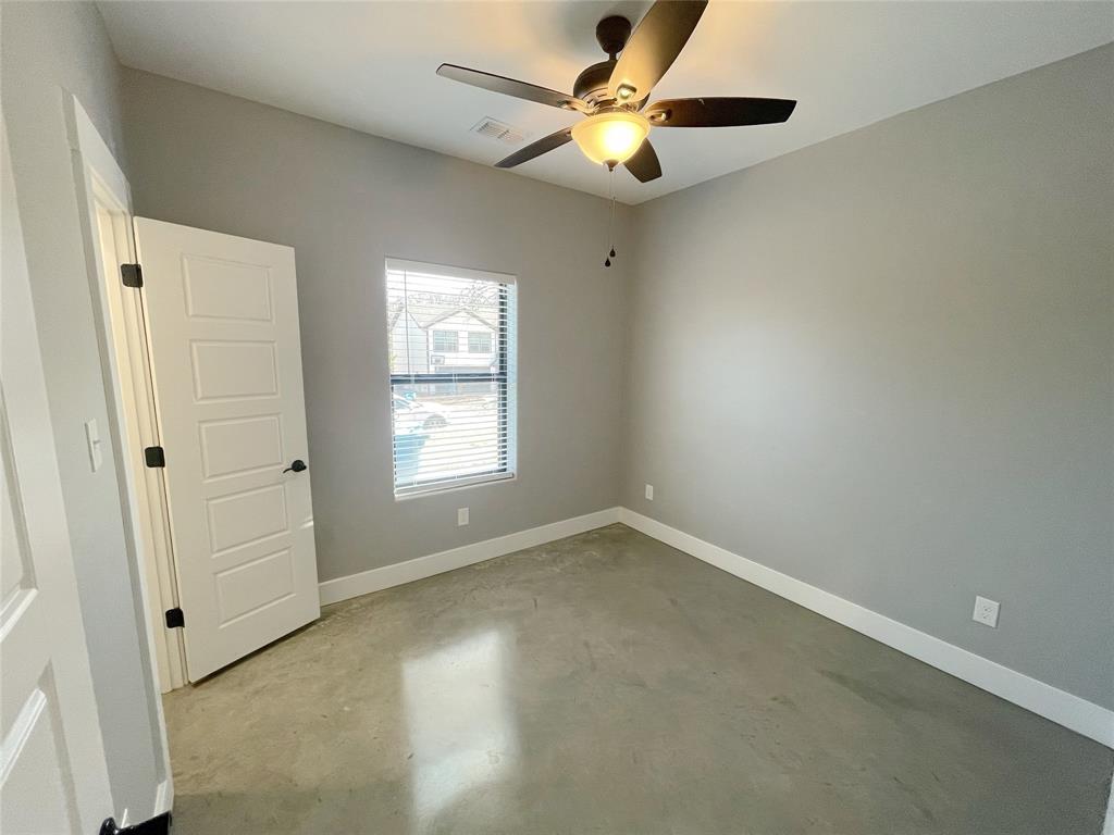 1215 Oak Drive, Unit 105 Denison, TX 75020 - Photo 16 of 17 an empty room with a window and a fan