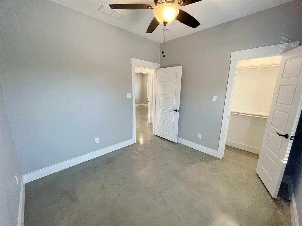1215 Oak Drive, Unit 105 Denison, TX 75020 - Photo 2 of 17 an empty room with a empty space and a ceiling fan