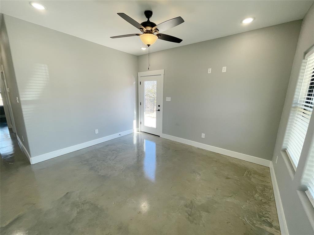 1215 Oak Drive, Unit 105 Denison, TX 75020 - Photo 4 of 17 wooden floor in an empty room with a window