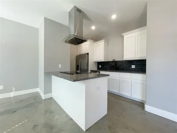 a kitchen with stainless steel appliances granite countertop a sink a stove and a refrigerator