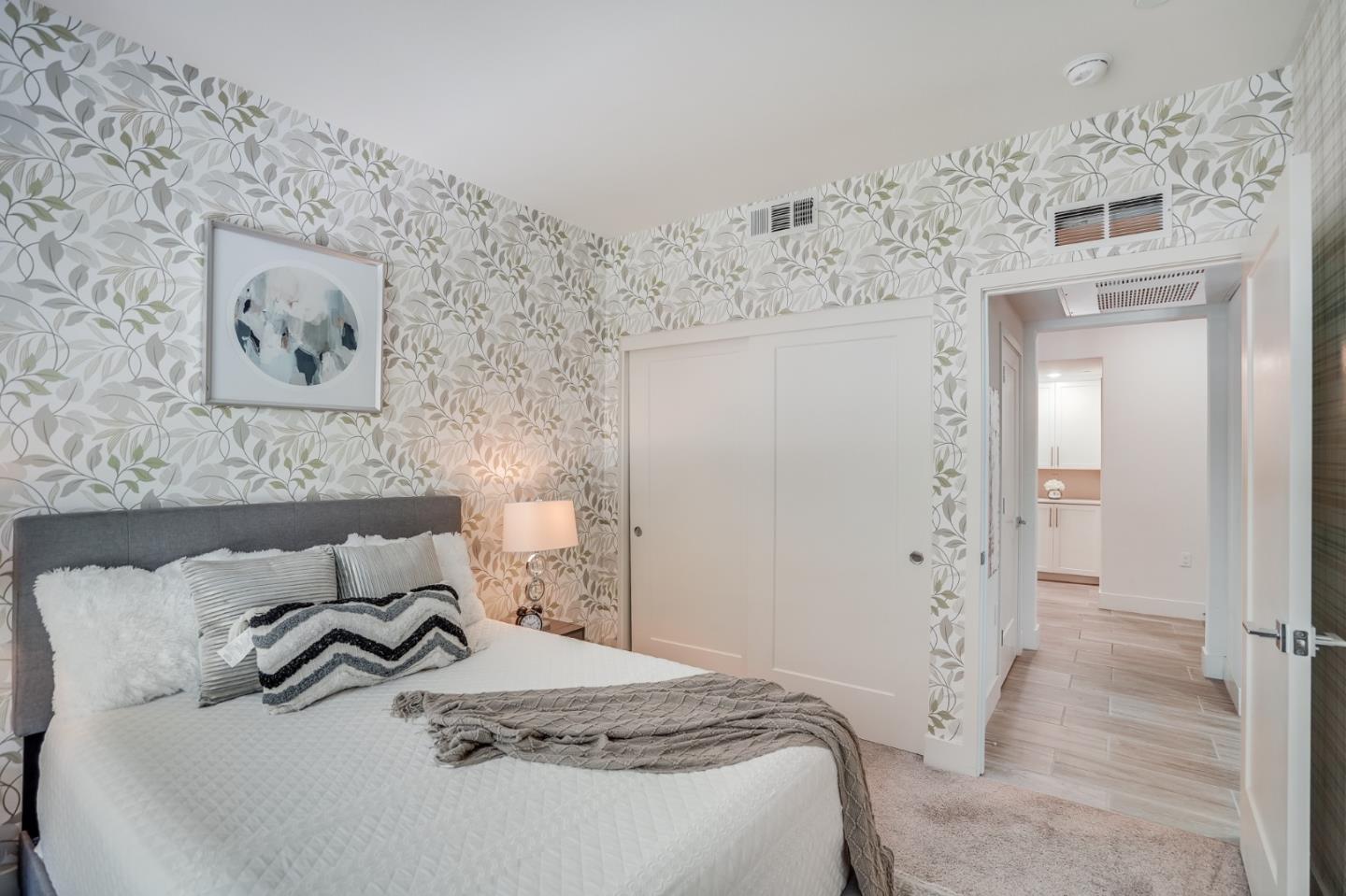 370 Riesling Avenue, Unit 20 Milpitas, CA 95035 - Photo 11 of 36 a bedroom with a bed and wall painting