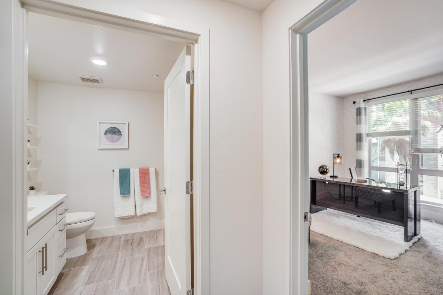 370 Riesling Avenue, Unit 20 Milpitas, CA 95035 - Photo 12 of 36 a bathroom with a granite countertop toilet a sink and a mirror