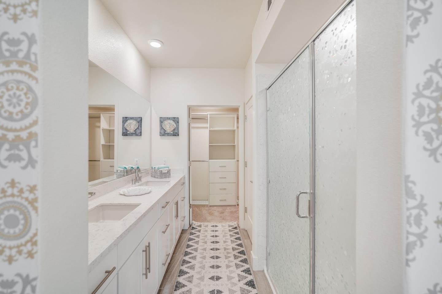 370 Riesling Avenue, Unit 20 Milpitas, CA 95035 - Photo 18 of 36 a spacious bathroom with a double vanity sink a mirror and a shower