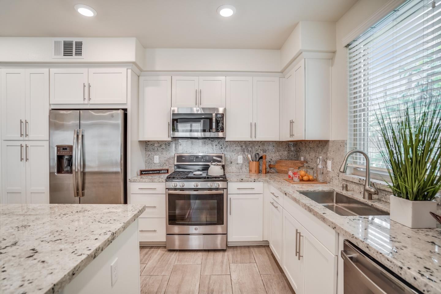 370 Riesling Avenue, Unit 20 Milpitas, CA 95035 - Photo 2 of 36 a kitchen with stainless steel appliances granite countertop a sink stove and refrigerator