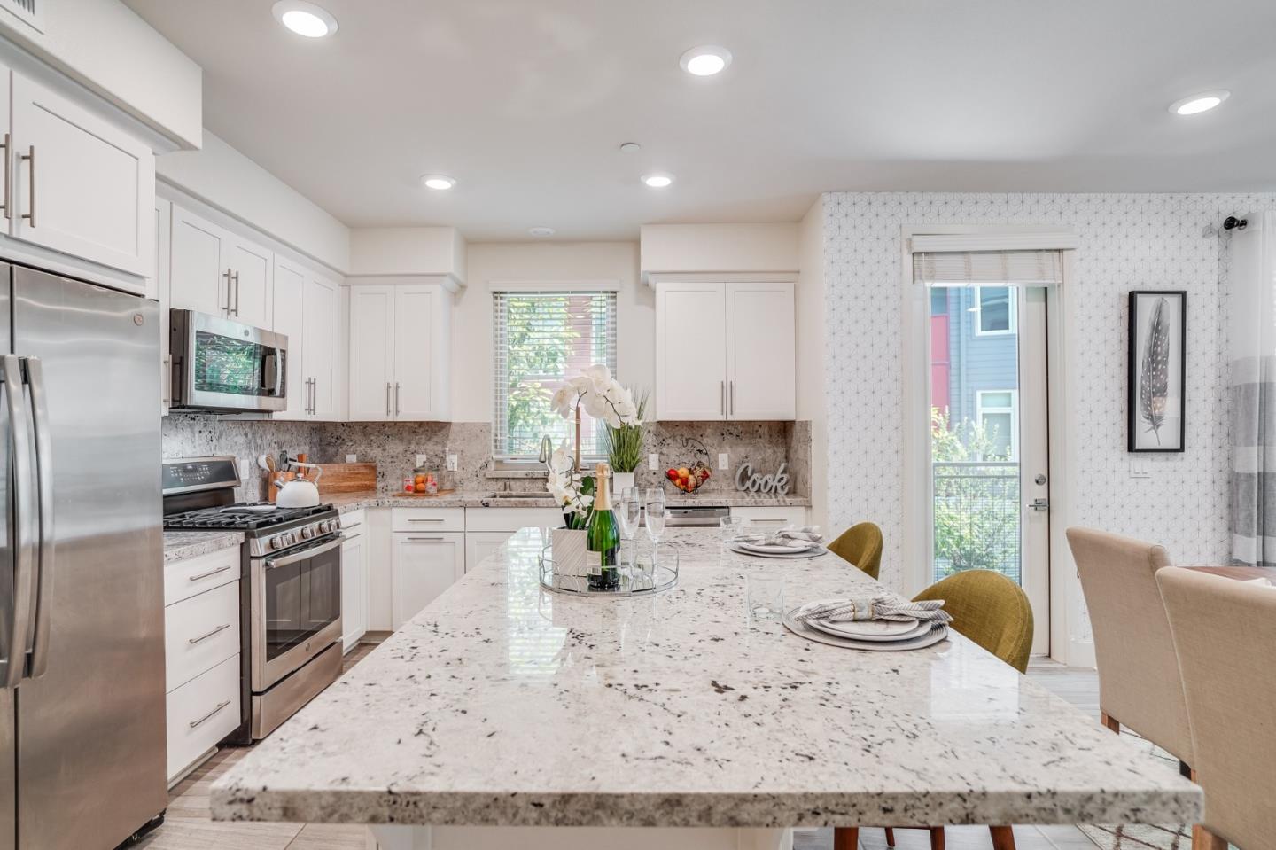 370 Riesling Avenue, Unit 20 Milpitas, CA 95035 - Photo 24 of 36 a kitchen with stainless steel appliances granite countertop a sink stove refrigerator and white cabinets with wooden floor