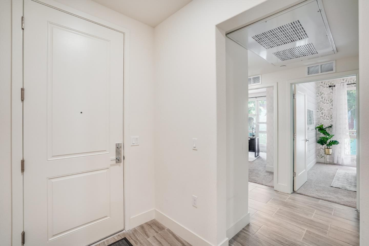 370 Riesling Avenue, Unit 20 Milpitas, CA 95035 - Photo 8 of 36 a view of a hallway with wooden floor and a bathroom