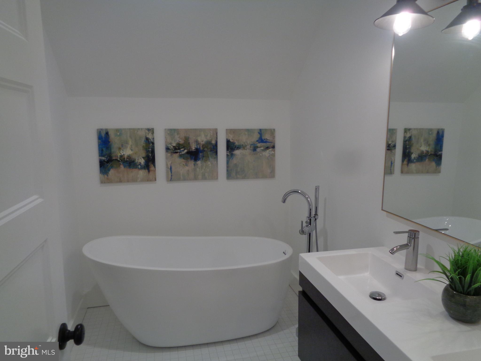 5105 Roland Avenue Baltimore, MD 21210 - Photo 11 of 19 a white bath tub sitting in a bathroom