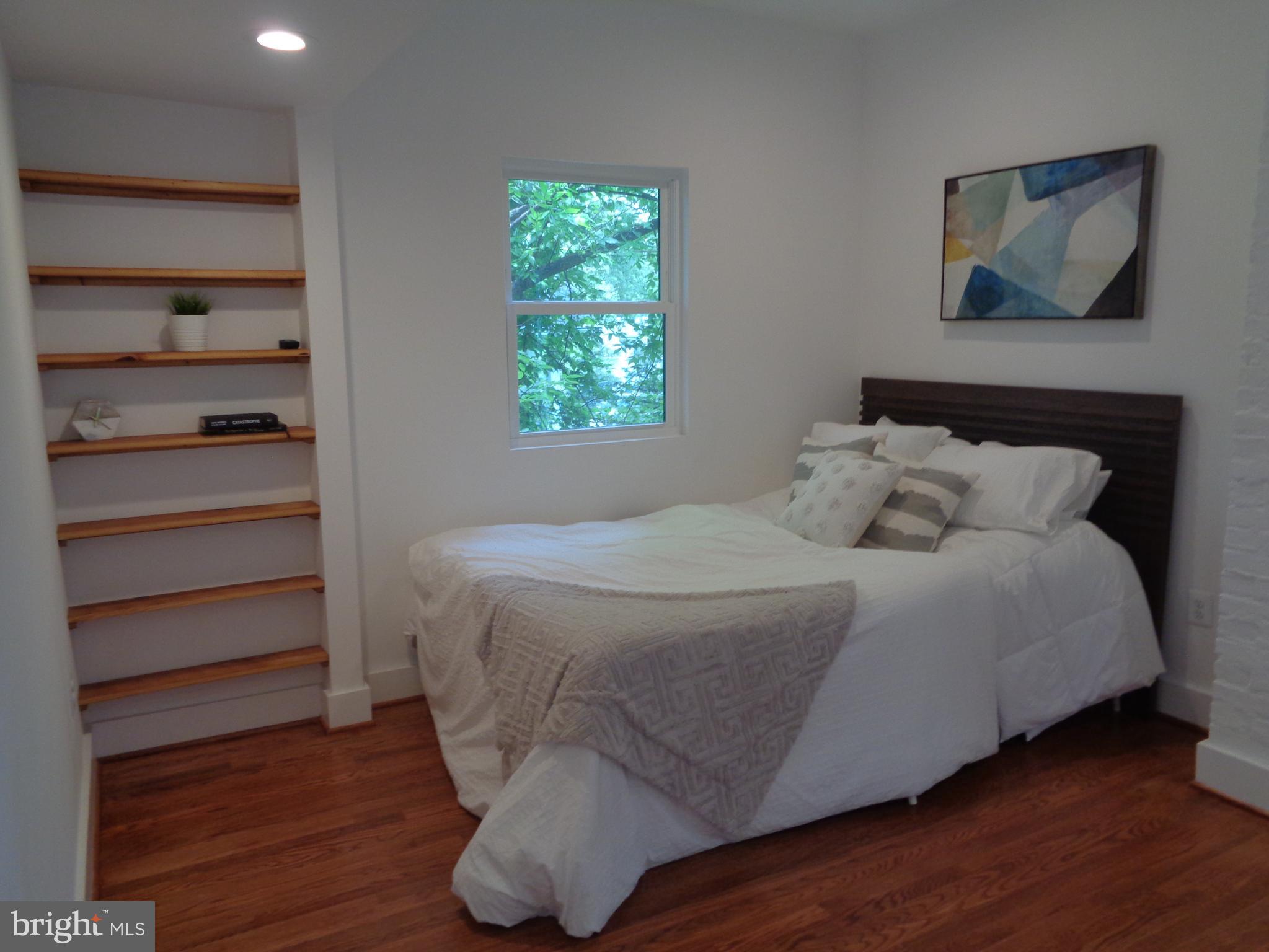 5105 Roland Avenue Baltimore, MD 21210 - Photo 12 of 19 a bedroom with a bed and a window